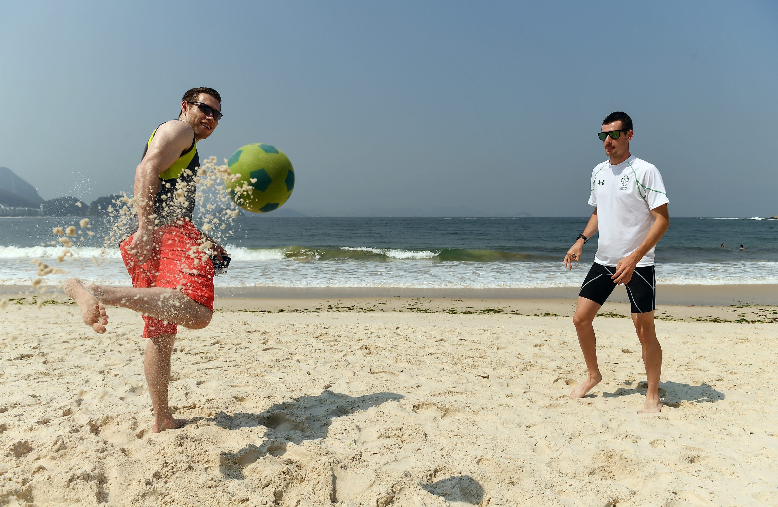 18 September 2016; Jason Smyth, left, and Michael McKillop of Ireland play football on the Copacabana beach where they gathered to support Patrick Monahan of Ireland, during the T54 Men's Marathon at Fort Copacabana during the Rio 2016 Paralympic Games in Rio de Janeiro, Brazil. Photo by Diarmuid Greene/Sportsfile *** NO REPRODUCTION FEE ***