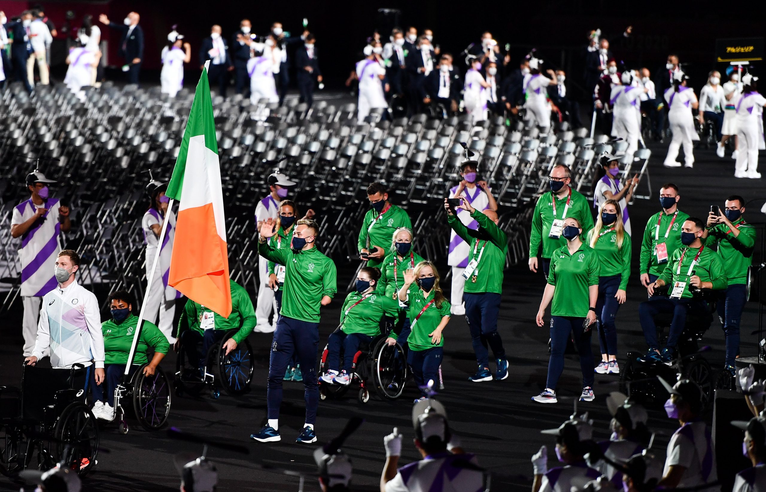 24 August 2021; Ireland flagbearers Jordan Lee, right, and Britney Arendse carry the Irish tri-colour during the Opening Ceremony of the Tokyo 2020 Paralympic Games at the Olympic Stadium in Tokyo, Japan. Photo by Sam Barnes/Sportsfile *** NO REPRODUCTION FEE ***