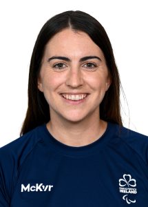 Hayley Burke smiling. Navy t shirt