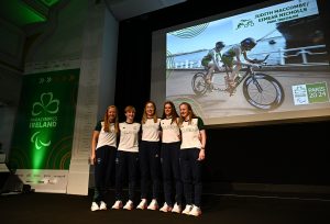 The Para triathlon team stand together on stage