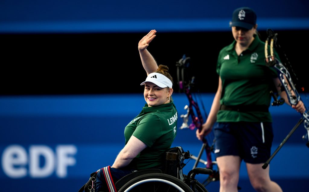Kerrie Leonard of Ireland waves to supporters before her women's individual compound open 1/16 elimination match against Zhou Jiamin of China during day two of the Paris 2024 Paralympic Games at Eplanade des Invalides in Paris, France.