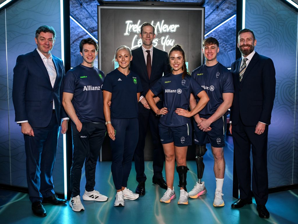From left, Peter Sherrard, Fintan McCarthy, Sarah Lavin, Phillip Gronemeyer (centre), Katie O’Brien, Tiarnán O’Donnell and Stephen McNamara stand together at the Allianz sponsorship announcement, posing in front of a branded backdrop.