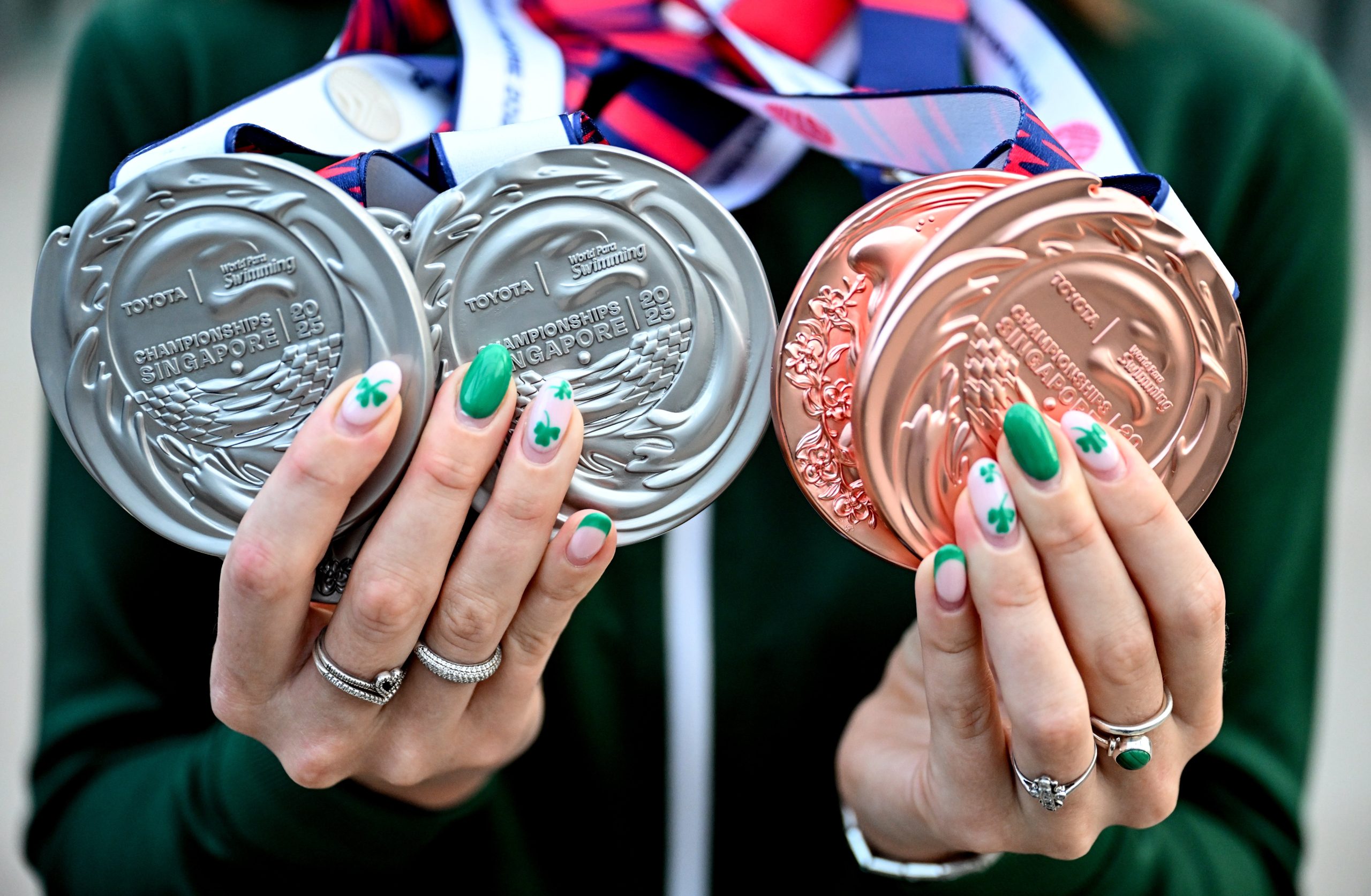 29 September 2025; Róisín Ní Riain with her World Championship medals, SB13 100m Breaststroke, silver; S13 100m Backstroke, silver; S13 400m Freestyle, silver; S13 100m Butterfly, bronze; SM13 200m Individual Medley, bronze; at Dublin Airport on Team Ireland's return from the Toyota World Para Swimming Championships at the OCBC Aquatic Centre in Singapore. Photo by Ramsey Cardy/Sportsfile *** NO REPRODUCTION FEE ***
