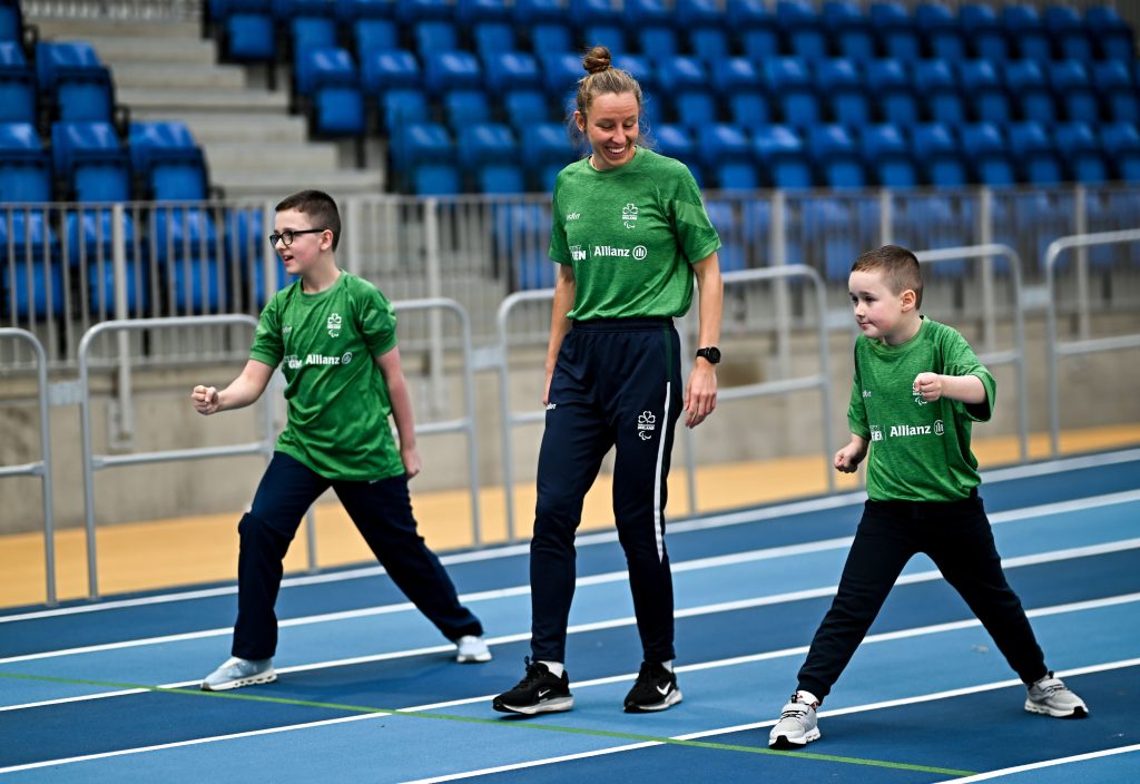 Greta Streimikyte racing two young children on a running track