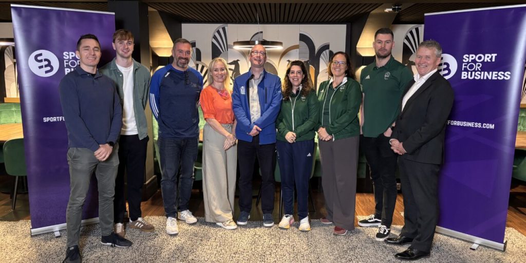 Picture of the 9 speakers in a row smiling at the Sport for Business Driving Inclusion event.