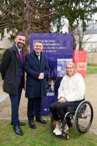 CEO Stephen McNamara standing to the right of Minister Pascal O'Donohue with President Eimear Breathnach seated to the minister's left