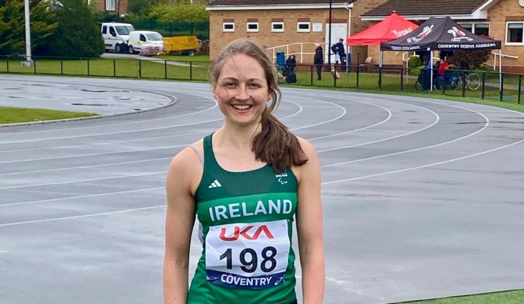 Lana Sutton poses for a picture following a race wearing a green Ireland racing singlet