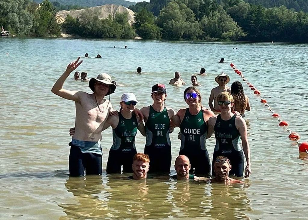 A group of eight Irish Para triathletes pose for a photo in the sea while celebrating after the European Para-triathlon Championships