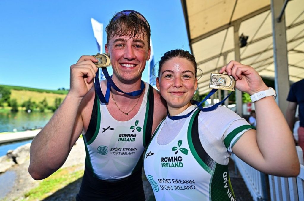 Tiarnán O’Donnell (left) and Sadhbh Ní Laoghaire (right) of Ireland smile and hold up their bronze medals after the PR3 mixed double sculls race at the World Rowing Cup in Lucerne.